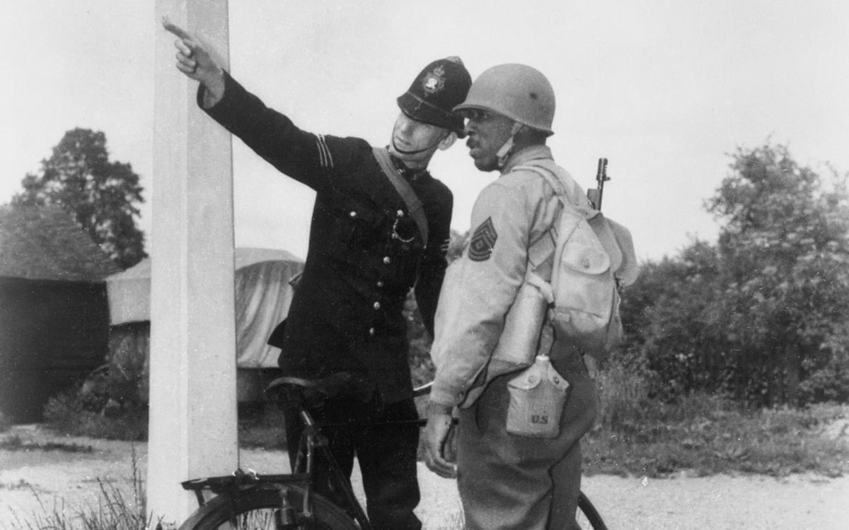 First Sergeant Elco Bolton encountering a policeman in Britain in June 1942