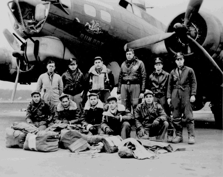 eleven men in Air Force uniform posed in two rows in front of a military airplane.  Six men standing to the rear and five men kneeling in front.  Some of the men are wearing cold-weather flying gear.