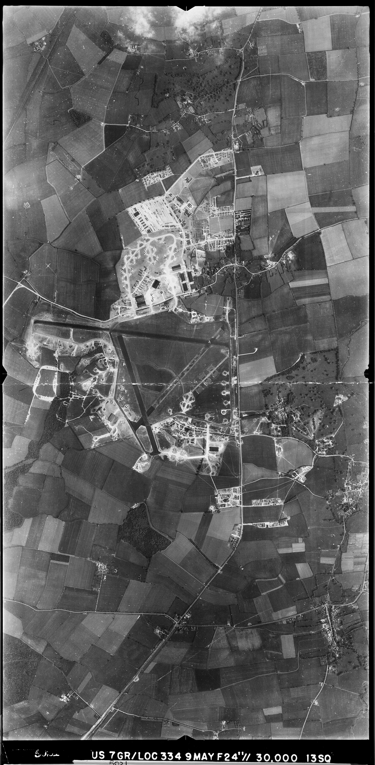 Aerial photograph of Alconbury airfield, looking east. The technical site is at the top, the bomb dump is on the left, 9 May 1944. Photograph taken by 13th Photographic Squadron, 7th Photographic Reconnaissance Group USAAF, sortie number US/7GR/LOC334. English Heritage (USAAF Photography).