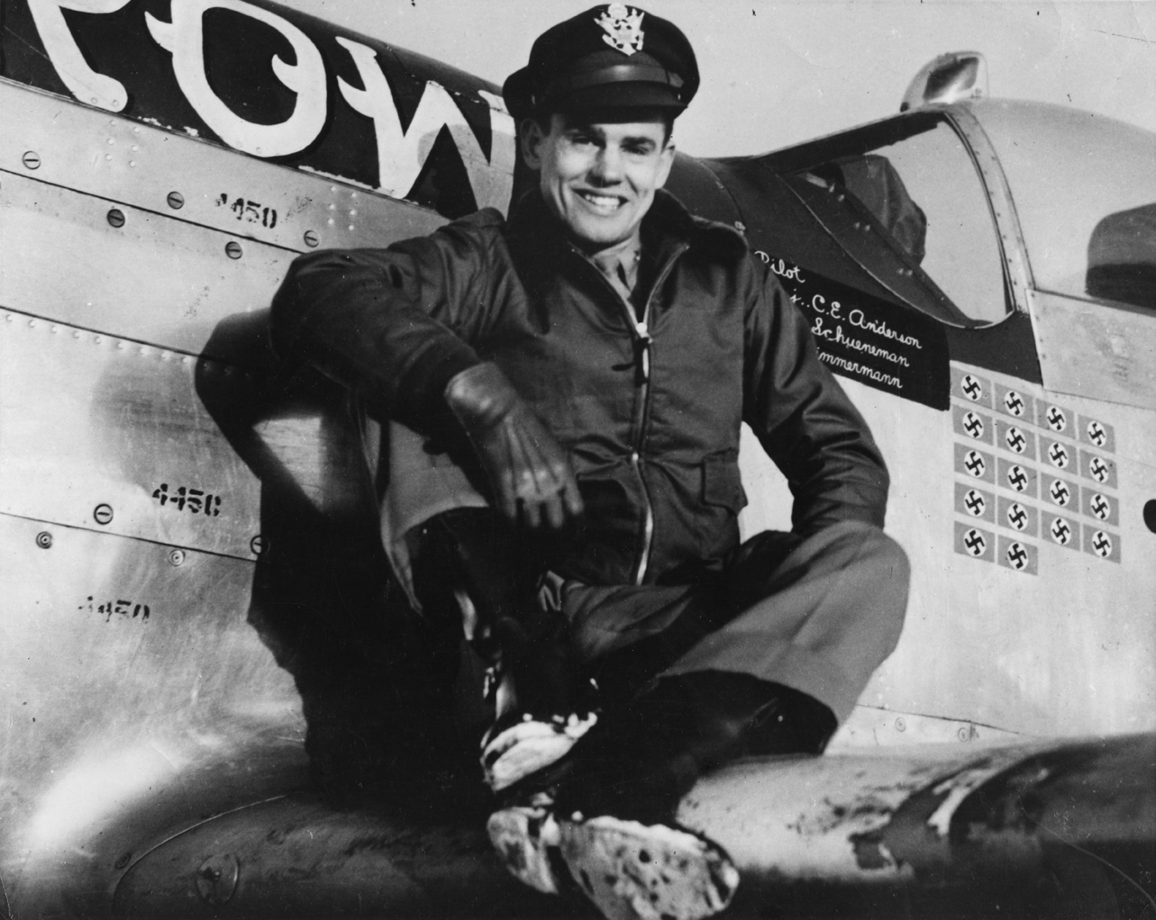 Captain Clarence E. Jr. "Bud" Anderson, ace of the 357th Fighter Group, sits on the wing of his P-51 Mustang (B6-S, serial number 43-12315) nicknamed "Old Crow". Image signed on reverse by Anderson. Handwritten caption on reverse: 'Major C E Anderson ace 357 FG. A/c name 'Old Crow'.