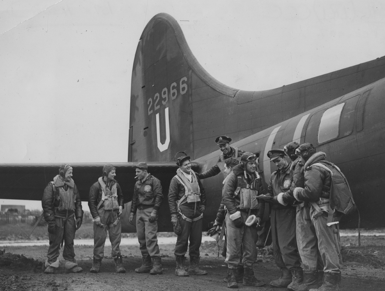 A bomber crew of the 303rd Bomb Group, with their B-17 Flying Fortress (GN-V, serial number 42-2966), after a raid on Germany. From left to right they are: Sergeant Ward W. Kirkpatrick (Kalispel, Montana); Technical Sergeant Lucian W. Means, (Luguna Beach, California); First Lieutenant Milton K. Conver (Cincinnatti, Ohio); Second Lieutenant John W Dillenger (Avoca, Iowa), Co-Pilot; Captain B.B. Southworth (Columbus, Ohio), Pilot; Sergeant Jack Belk (Temple, Texas); Sergeant William Fleming (Burdine, Kentu