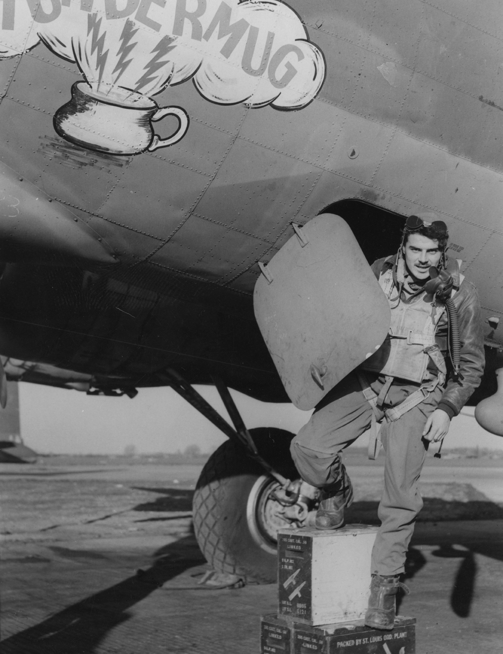 Lieutenant John R Winberg of the 305th Bomb Group climbs into a B-17 Flying Fortress (serial number 42-38205) nicknamed "Thundermug". Image stamped on reverse: 'Associated Press.' [stamp], 'Passed for Publication 10 Mar 1944.' [stamp] and '310547.' [Censor no.] Printed caption on reverse: '"THUNDERMUG" MAKES THREE BERLIN TRIPS. Associated Press Photo Shows: Lt. John R. Wineberg of Sioux Falls, S. Dakota, emerges from the Fortress "Thundermug" which has been to Berlin three times in four days. ASH265809 10