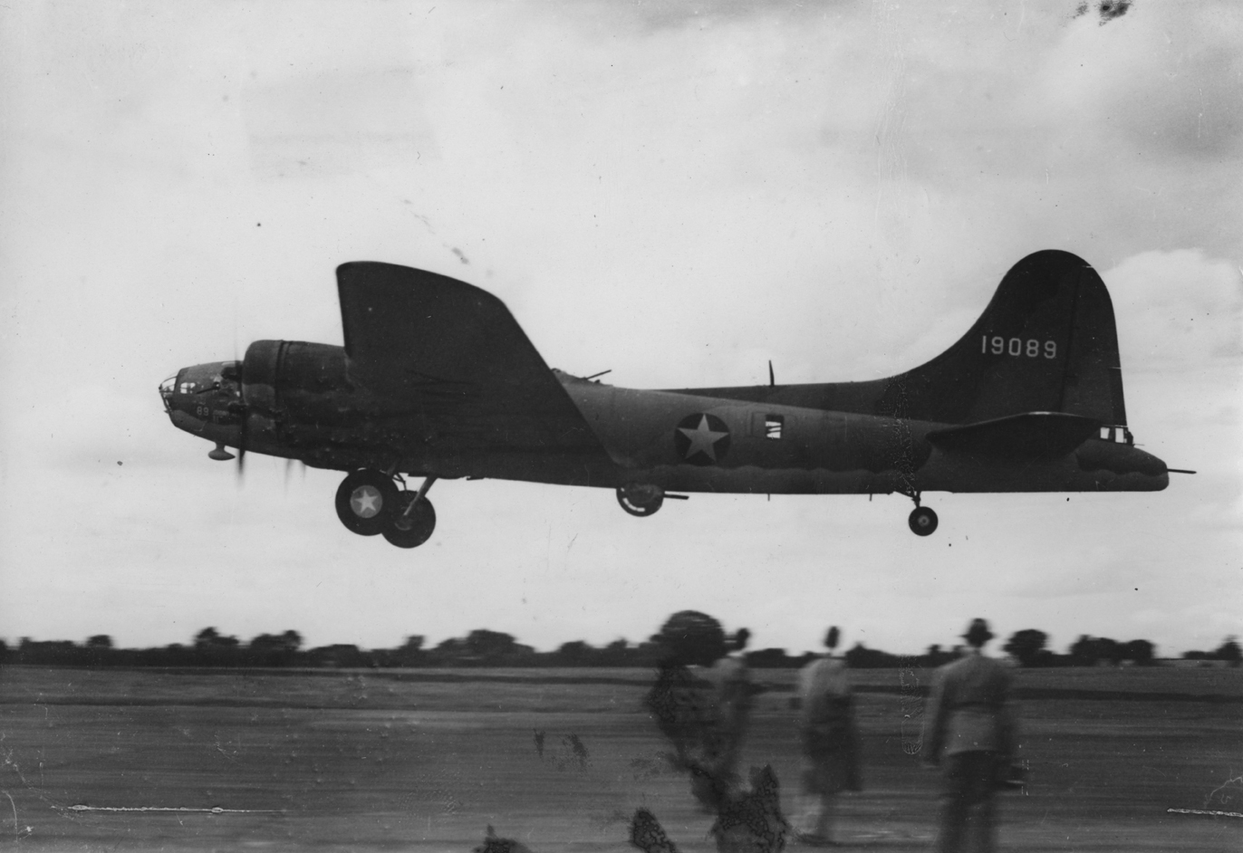 A B-17 Flying Fortress (serial number 41-9089) nicknamed "Johnny Reb" of the 92nd Bomb Group, formerly of the 97th Bomb Group takes off. Image stamped on reverse: 'New York Times Photo.' [stamp], 'Air (Boeing) FLY.' [annotation] and '219847.'[Censor no.] A printed caption was previously attached the the reverse however this has been lost. Handwritten caption on reverse: '4/9/42, marsh ground. Johnny Reb.'