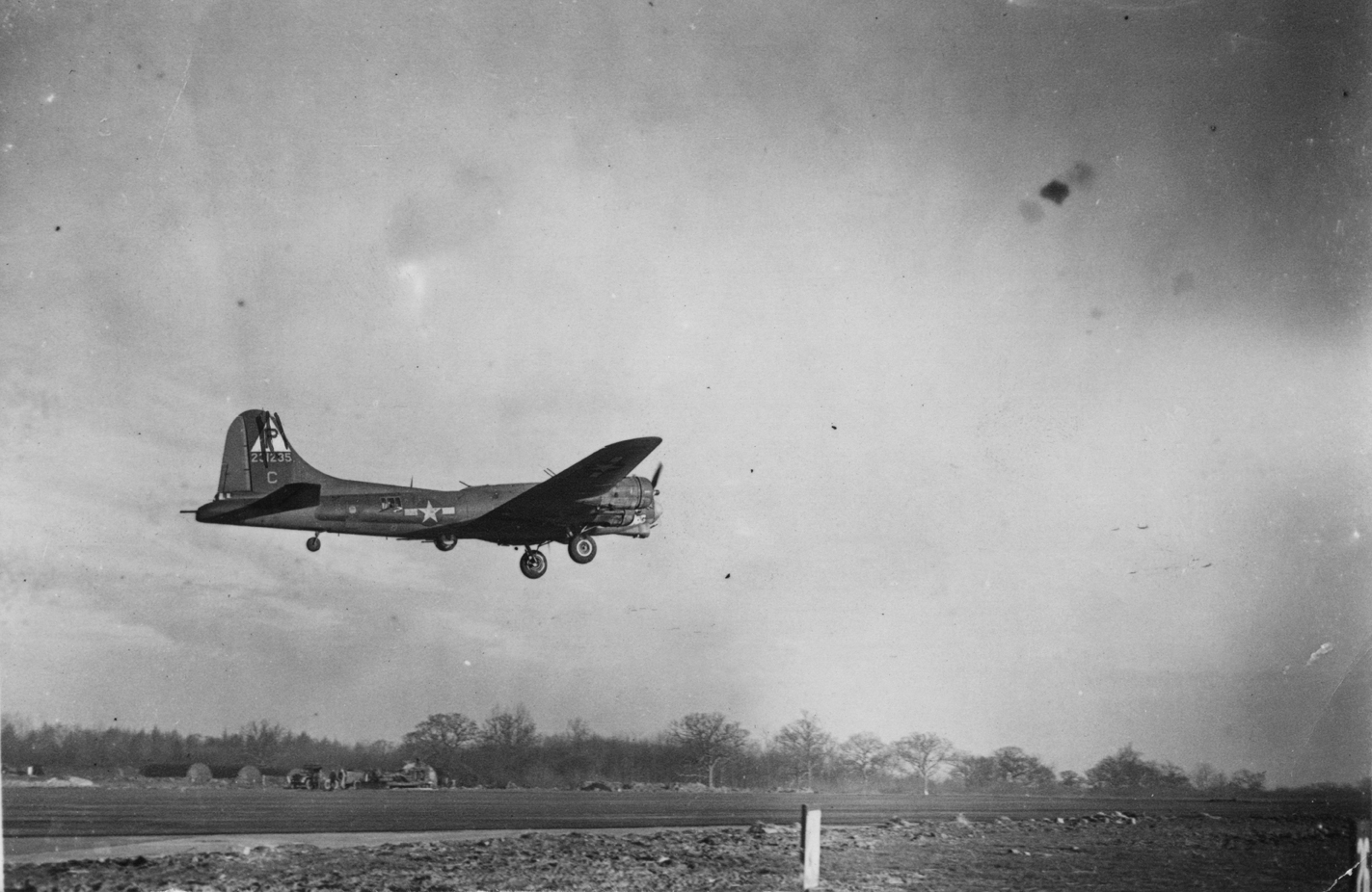 A B-17 Flying Fortress (serial number 42-31235) nicknamed 'Goin' Dog' of the 384th Bomb Group takes off for a mission. A censor has obscured the triangle P and serial number on the aircraft's tail. Image stamped on reverse: 'Sport and General.' [stamp], 'Passed for publication 24 April 1944.' [stamp] and '313357.' [Censor no.] Printed caption on reverse: 'Back from Berlin. Crews of US Fortress Station returning from the Berlin raid which took place recently. 34320. A Fortress takes off- destination Berlin