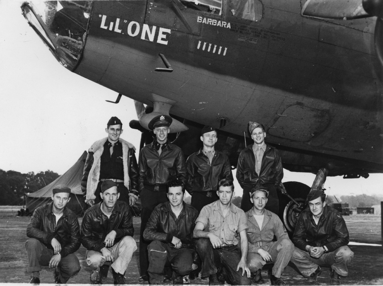 Bob Pfieffer and his crew of the 562nd Bomb Squadron, 388th Bomb Group with their B-17 Flying Fortress (serial number 42-30213) nicknamed "Lil' One". Handwritten caption on reverse: 'Bob Pfieffer crew, 562BS.'