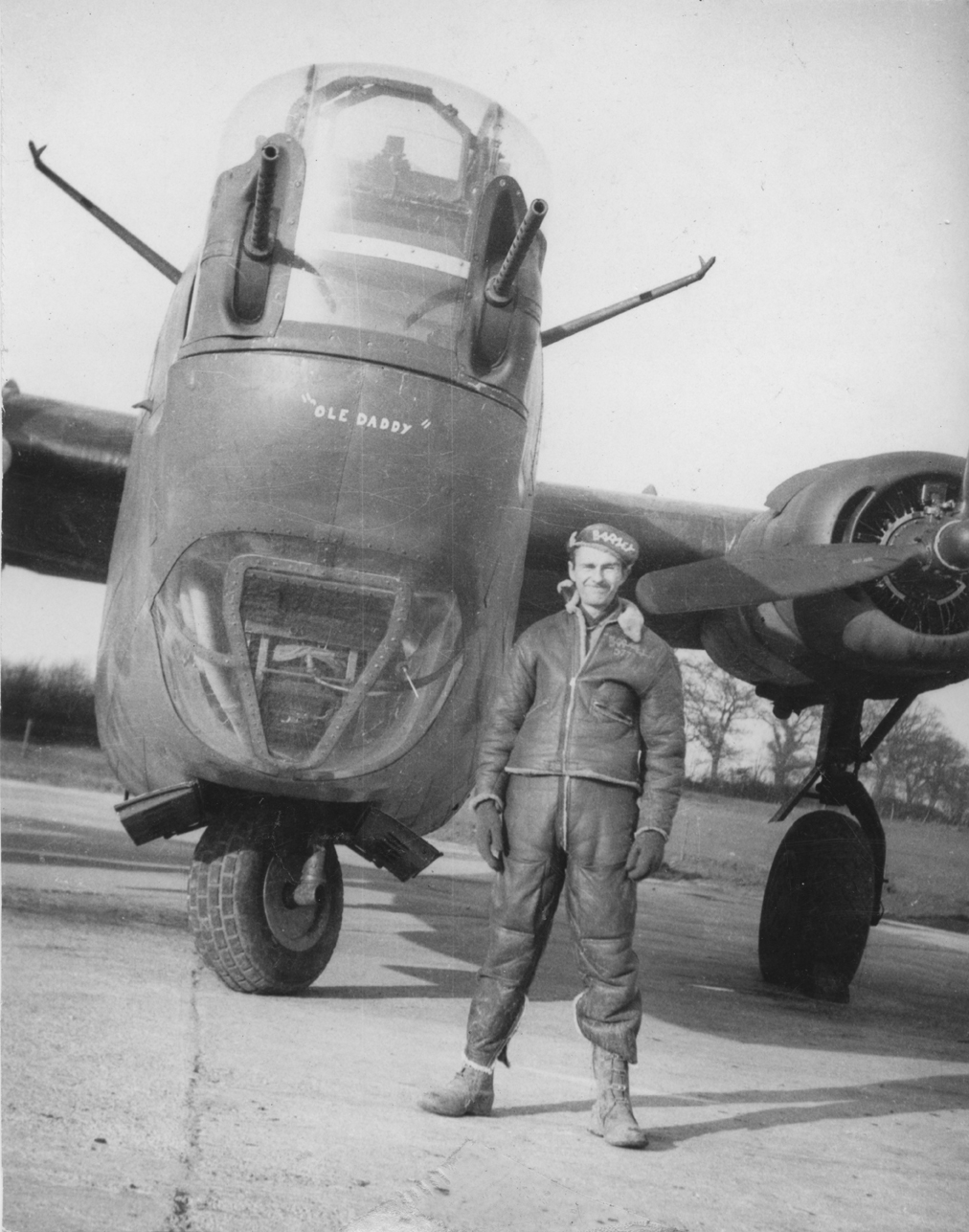 An airman of the 392nd Bomb Group with a B-24 Liberator. Image via John E Bode