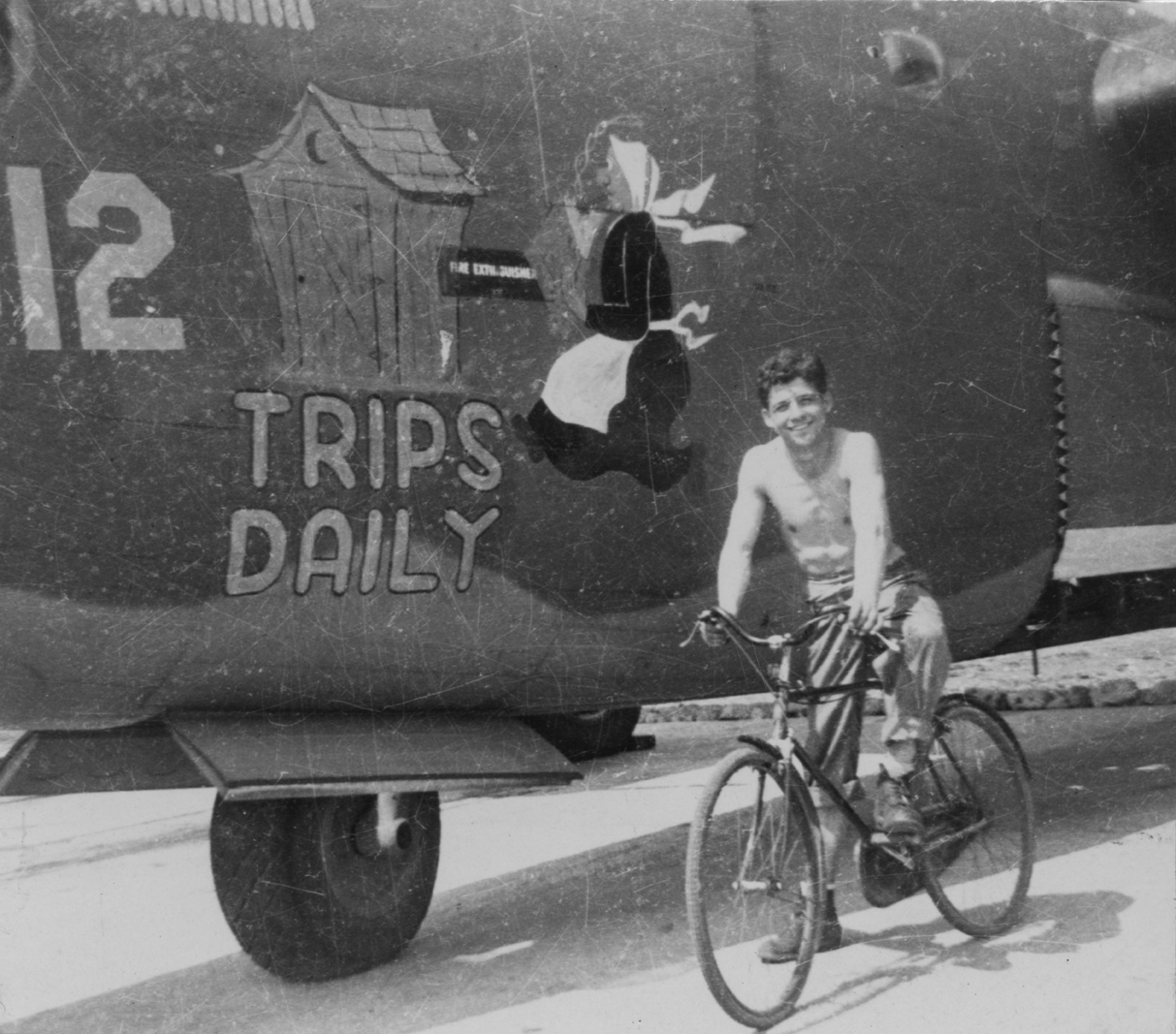 An airman of the 392nd Bomb Group with a B-24 Liberator (serial number 42-95012) nicknamed "Trips Daily" Image via John E Bode