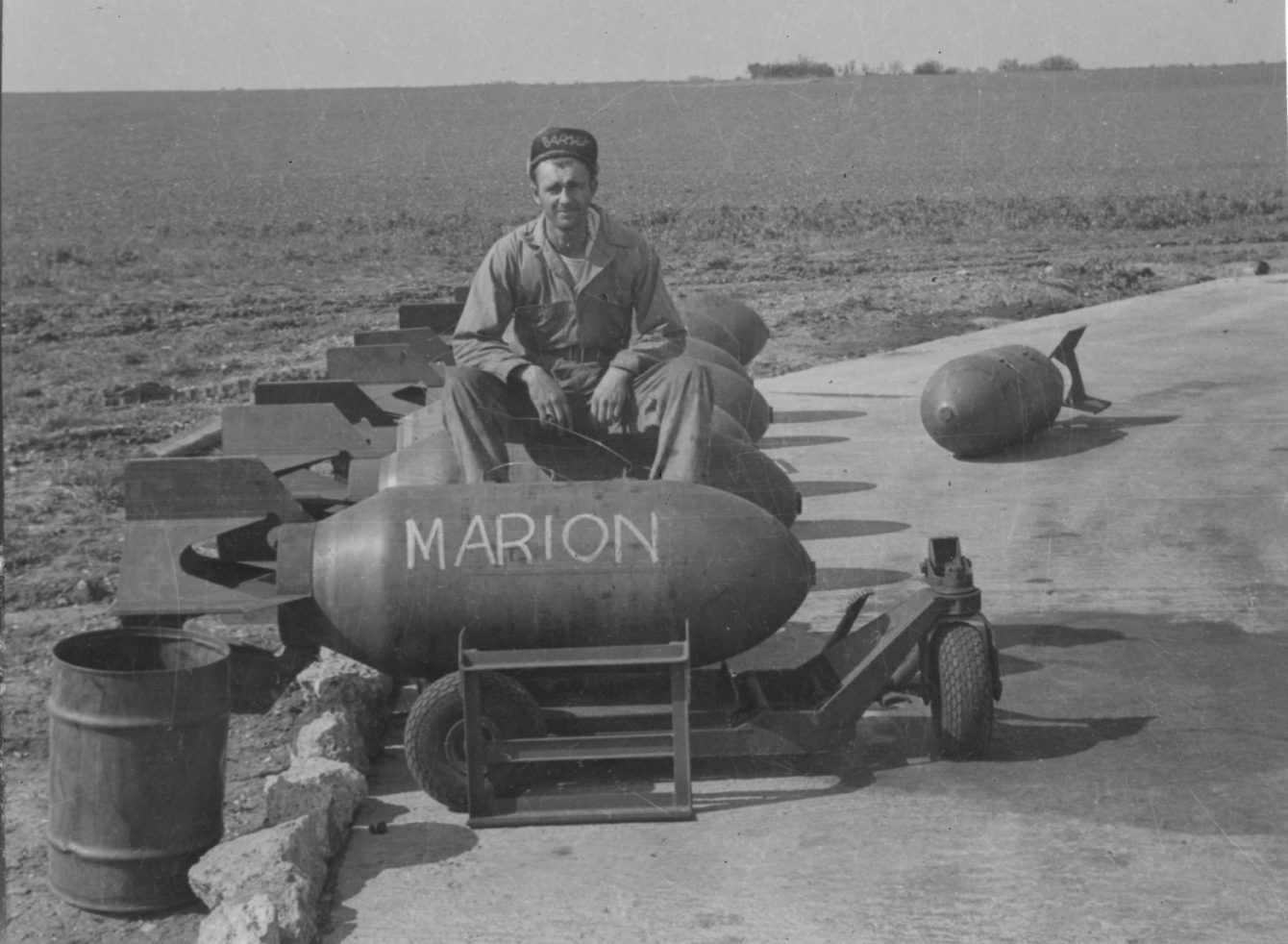 Corporal Whitney Barnes of the 392nd Bomb Group with a bomb inscribed "Marion" in honour of his wife. Image via John E Bode