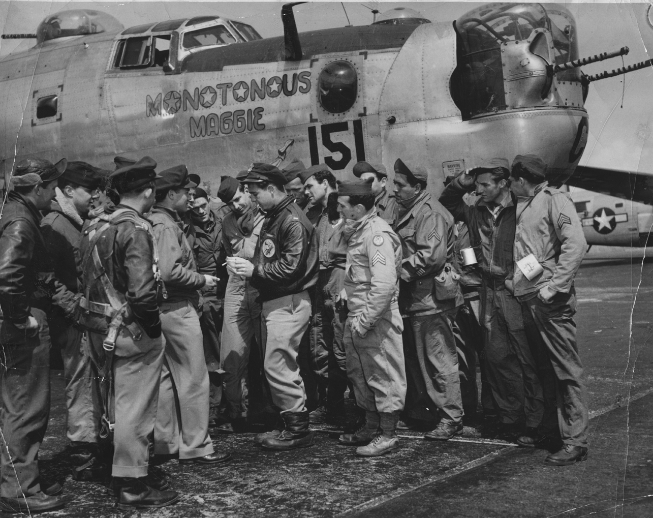 First Lieutenant Richard Steck of the 392nd Bomb Group instructs his crew and 10 passengers before a flight from Wales in a  B-24 Liberator (serial number 42-95151) nicknamed "Monotonous Maggie". 

Image via BL Davies. 

Image stamped on reverse: 'Official USAAF Photograph By AIR TRANSPORT COMMAND.' [stamp] 

Printed caption on reverse: 'June 1945. ATC Euro Pro Release No. G-128 AIR TRANSPORT COMMAND SPEEDS US EIGHTH AAF ON ITS WAY: Flying Air Transport Command routes and using ATC facilities, the U