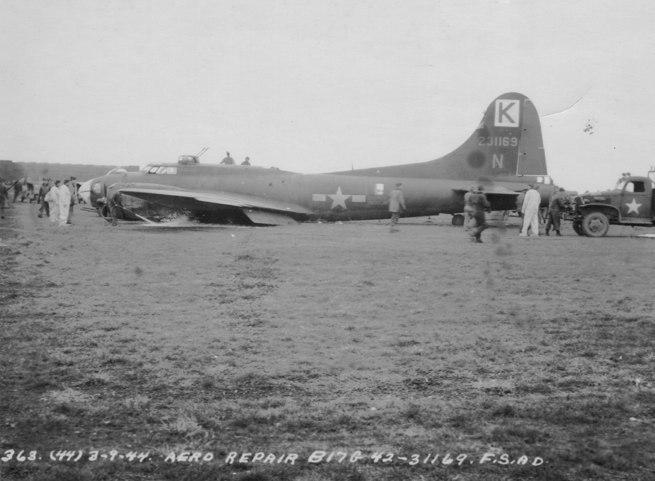 A crashed B-17 Flying Fortress (serial number 42-31169) nicknamed "Hey Mabel!" of the 447th Bomb Group. Official caption printed on image: '363 (44) 3-9-44 Aero Repair. B17G 42-31169. FSAD.' Image stamped on reverse: 'Official Photograph Photo section US Army.' First handwritten caption on reverse: 'B-17G-5-BO. S/N 42-31169 Hey Mabel!' Second handwritten caption on reverse: '447th Bomb Group 4th Combat Wing 3rd Air Div.'