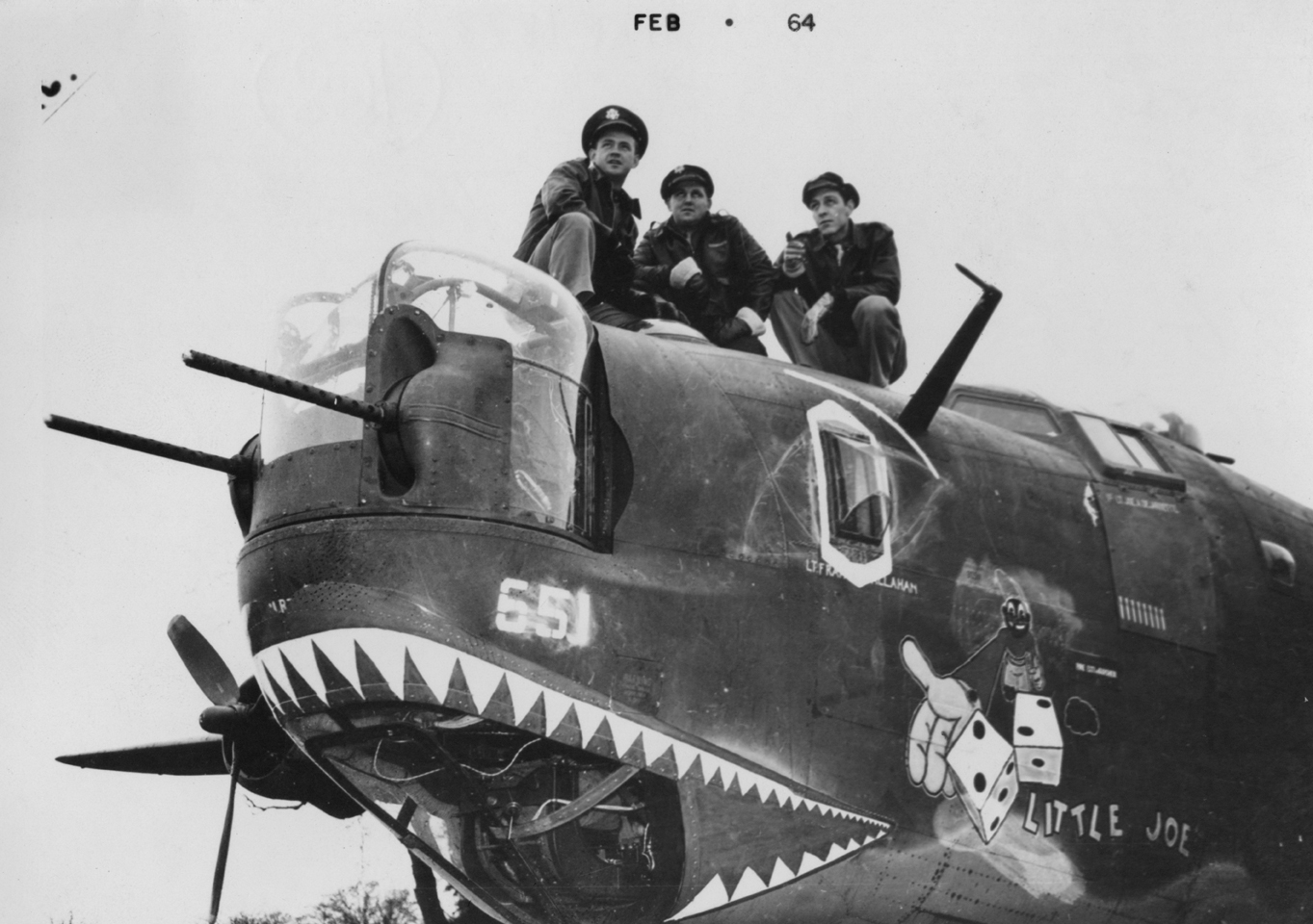 Three airmen of the 453rd Bomb Group sit atop a shark mouth B-24 Liberator (serial number 42-52185) nicknamed "Little Joe". Image via Kenneth W Clendenin. Handwritten caption on reverse: 'Roger this one of the 453rd BG is self-explanatory- "N'est ce pas".'