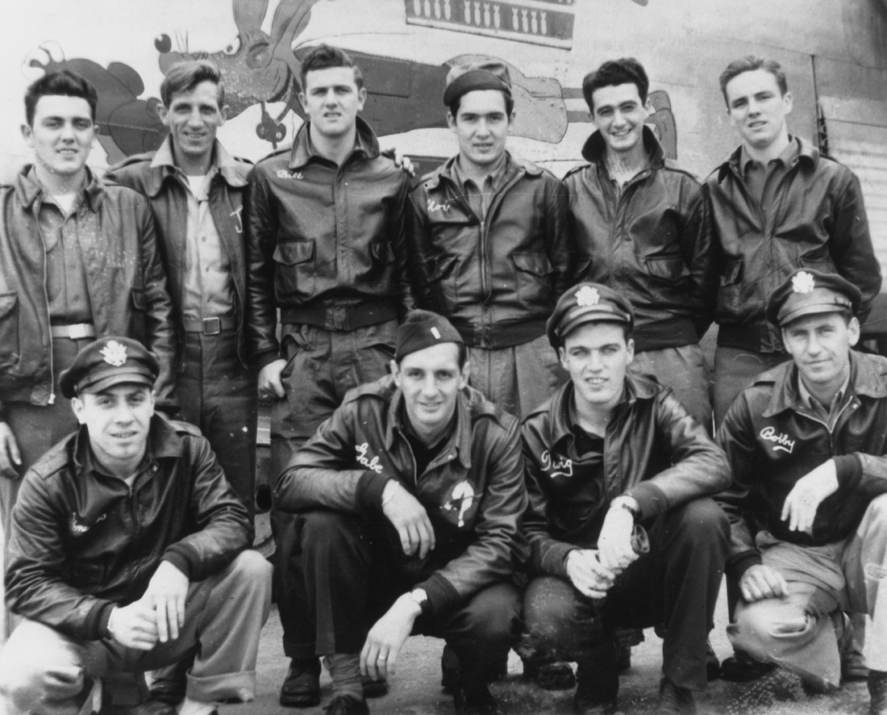 A bomber crew of the 458th Bomb Group and their B-24 Liberator. Handwritten caption on reverse: 'John Ourcio 2nd from rt, age 19. 458 BG.'