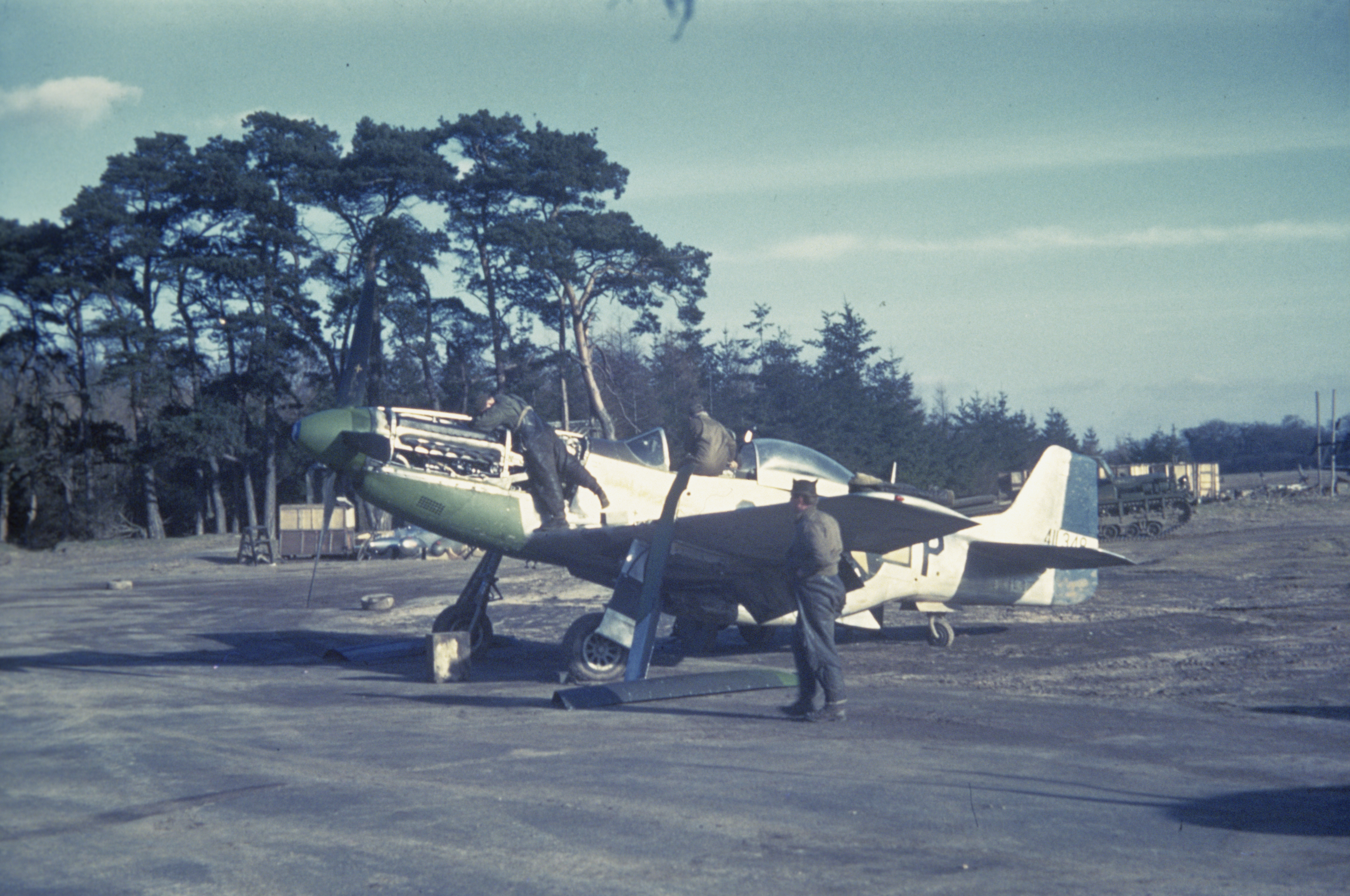 Ground personnel of the 359th Fighter Group work on a P-51 Mustang (CS-R, serial number 44-11348) nicknamed "Oh Nurse!". Associated caption: 'CS-R (leg of R is mission so looks like a P) being worked on.'