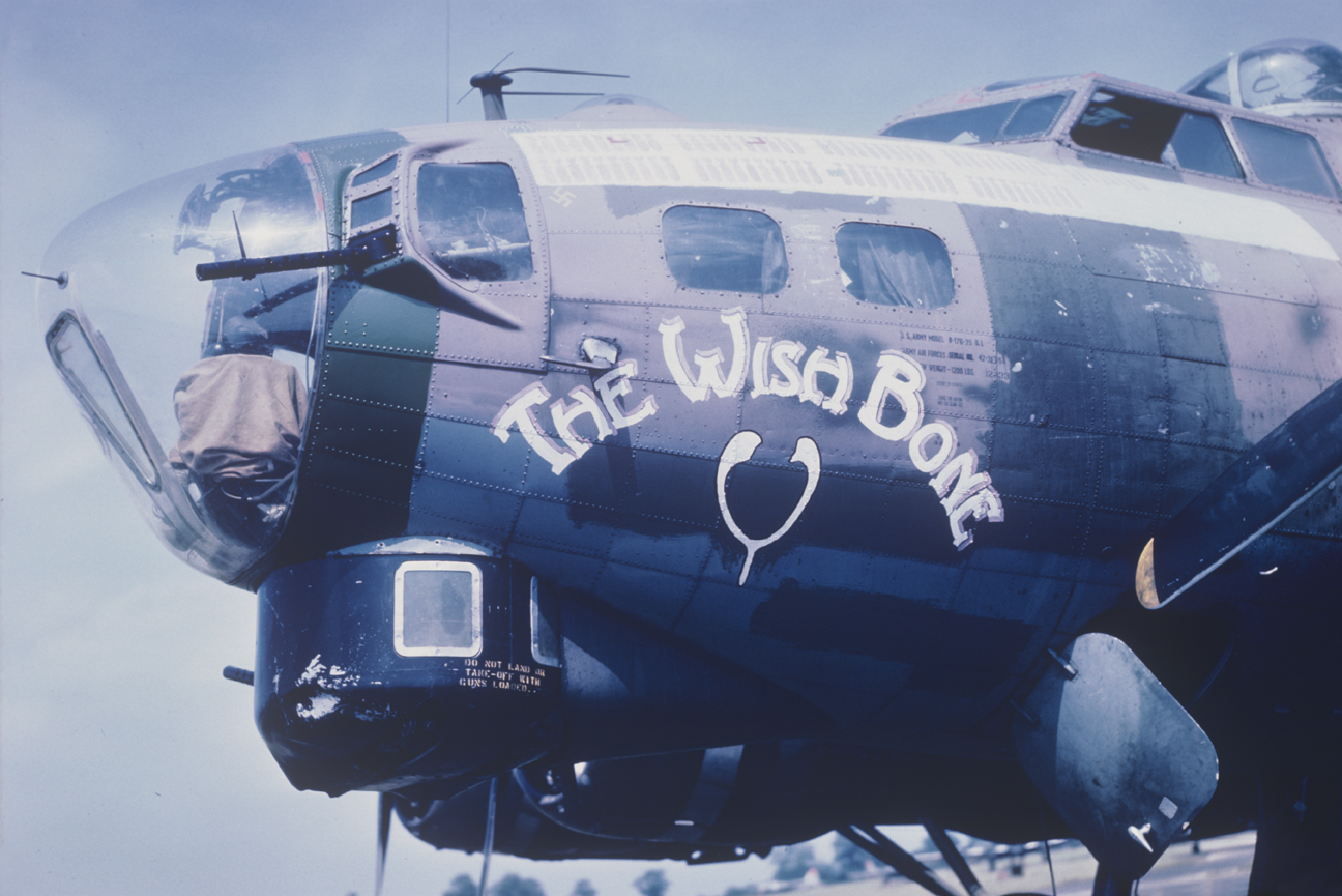 The nose art of a B-17 Flying Fortress (serial number 42-38058) nicknamed "The Wish Bone" of the 490th Bomb Group at Eye. Image by Captain Arnold Delmonico, photographic officer 490th Bomb Group. Written on slide casing: 'After transfer to 490 BG at Eye.