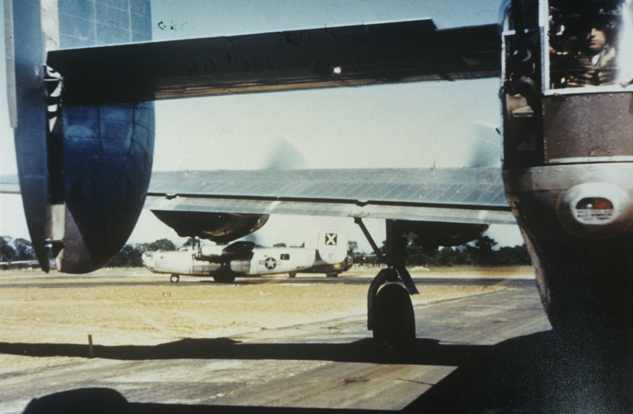 B-24 Liberators of the 493rd Bomb Group line up for take off. A tail gunner can be seen in position inside his aircraft. Image via Mark Brown, AFA