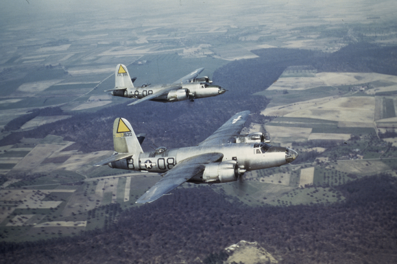 Two B-26 Marauders (O8-B, serial number 42-107620) nicknamed "Oh Baby" and (O8-O, serial number 42-96295) nicknamed "Cook's Tour" of the 391st Bomb Group fly together over France. Image via Alvaro Sousa. Written on slide casing: '"Wing Men" 391st-575 B. Sqdn, France 1944.' Written on duplicate slide: '2 Ship B-26 formation over France.'