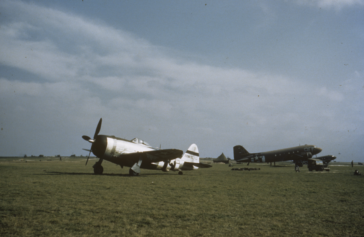 A P-47 Thunderbolt (serial number 42-28875) and a C-47 Skytrain (90-M, serial number 42-100806) of the 437th Troop Carrier Group at Nordholz, May 1945. Image via John Quincy.