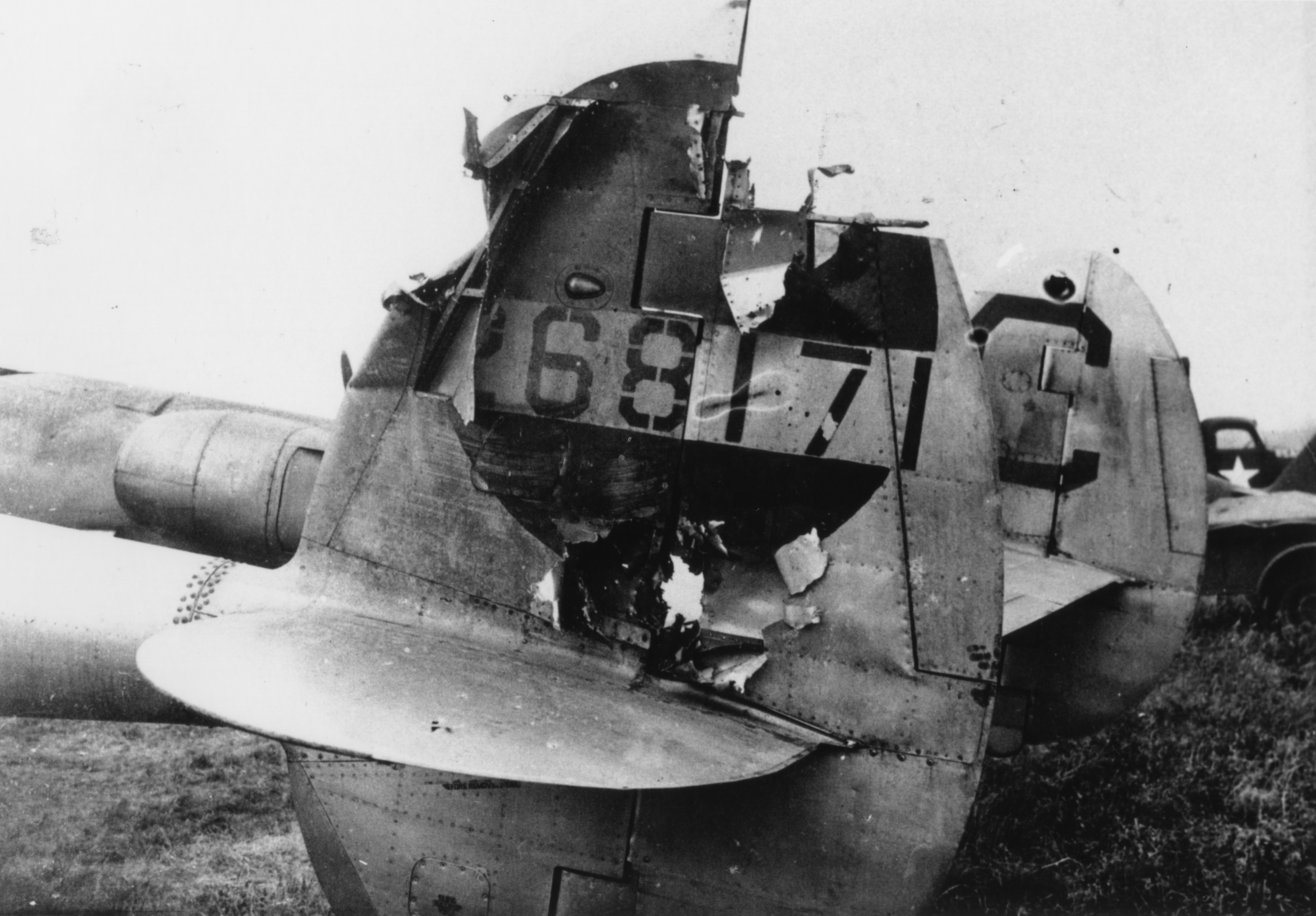 A damaged P-38 Lightning (LC-C, serial number 42-68171) of the 77th Fighter Squadron, 20th Fighter Group. Handwritten caption on reverse: 'via C. Thomas. Wormswell?? LC-C.'