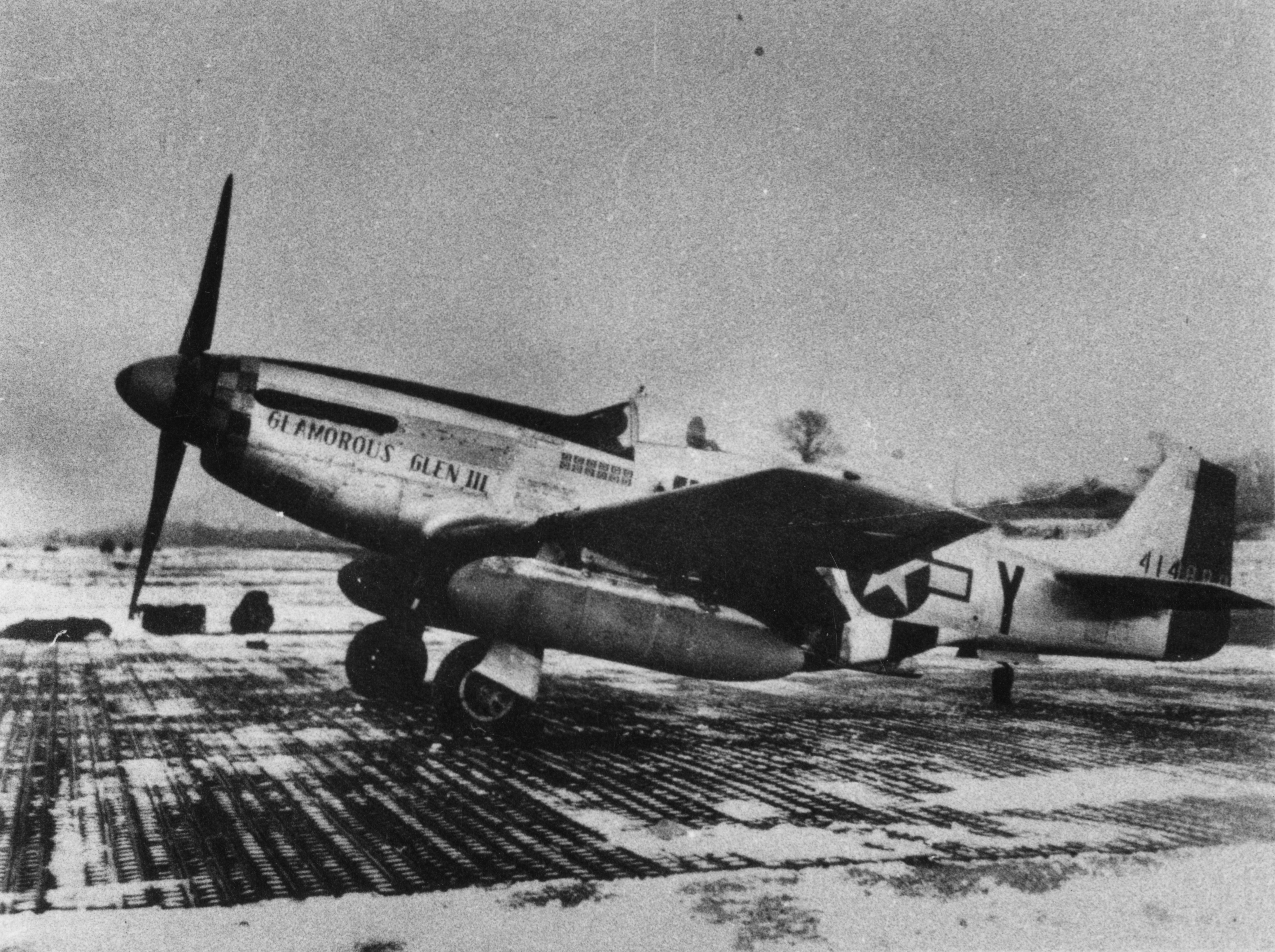 A P-51 Mustang (B6-Y) nicknamed "Glamorous Glen III" of the 363rd Fighter Squadron, 357th Fighter Group, flown by Chuck Yeager. Handwritten caption on reverse: 'Glamorous Glen III, B6-Y, 357th/363rd. Chuck Yeager.' On reverse: "B & C" Associates and Kenneth W. Clendenin [Stamps].