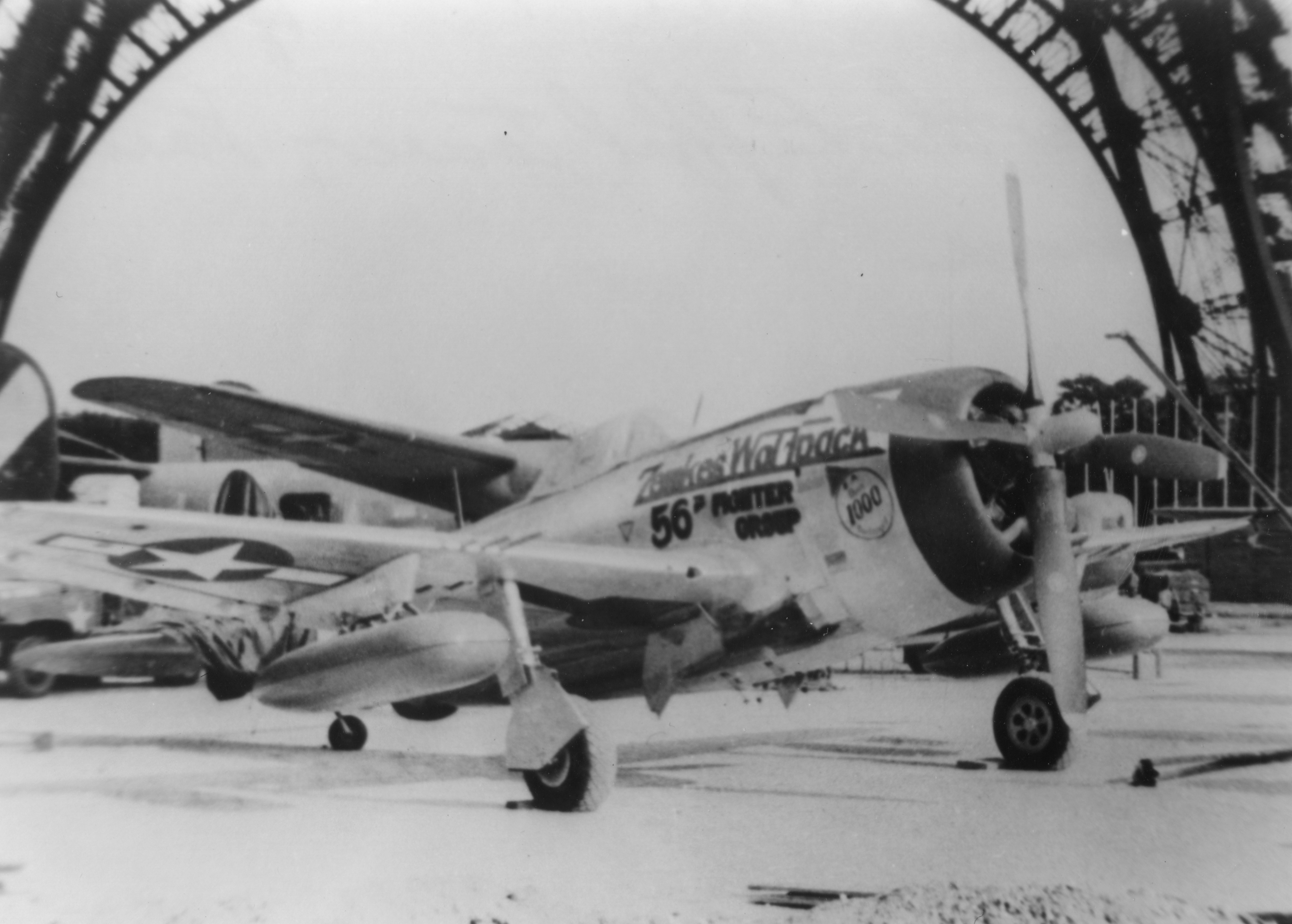 A P-47 Thunderbolt (serial number 44-21175) commemorating the service of Colonel Hubert Zemke of the 56th Fighter Group and 479th Fighter Group, on display at the Eiffel Tower, 1945. Handwritten caption on reverse: 'June 1945 - P-47H under the Eiffel Tower, Paris, France.'