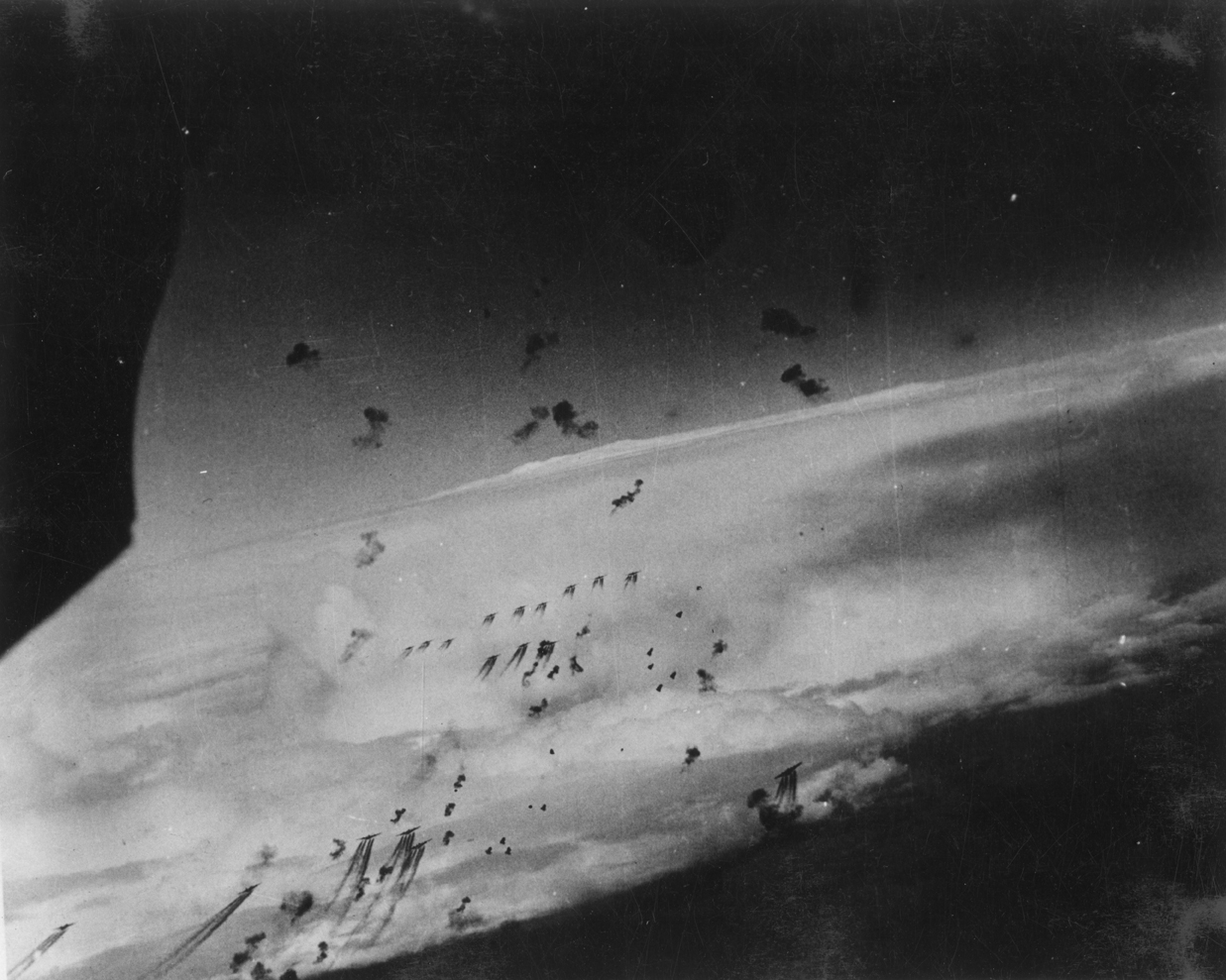 B-17 Flying Fortresses of the 91st Bomb Group fly through flak bursts during a mission.