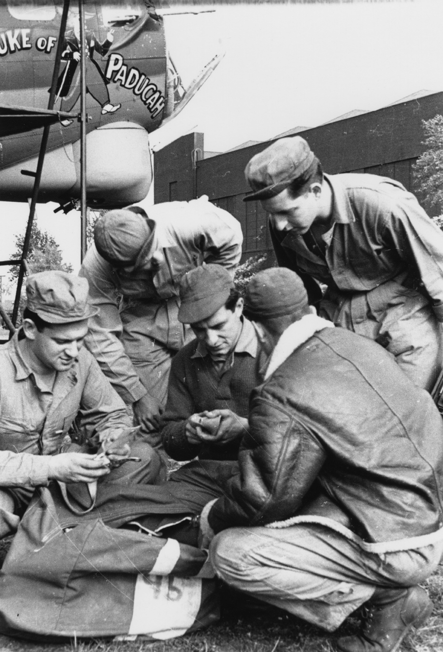 Ground personnel of the 91st Bomb Group examine equipment under the nose of a B-17 Flying Fortress nicknamed "Duke of Paducah" at Bassingbourn.