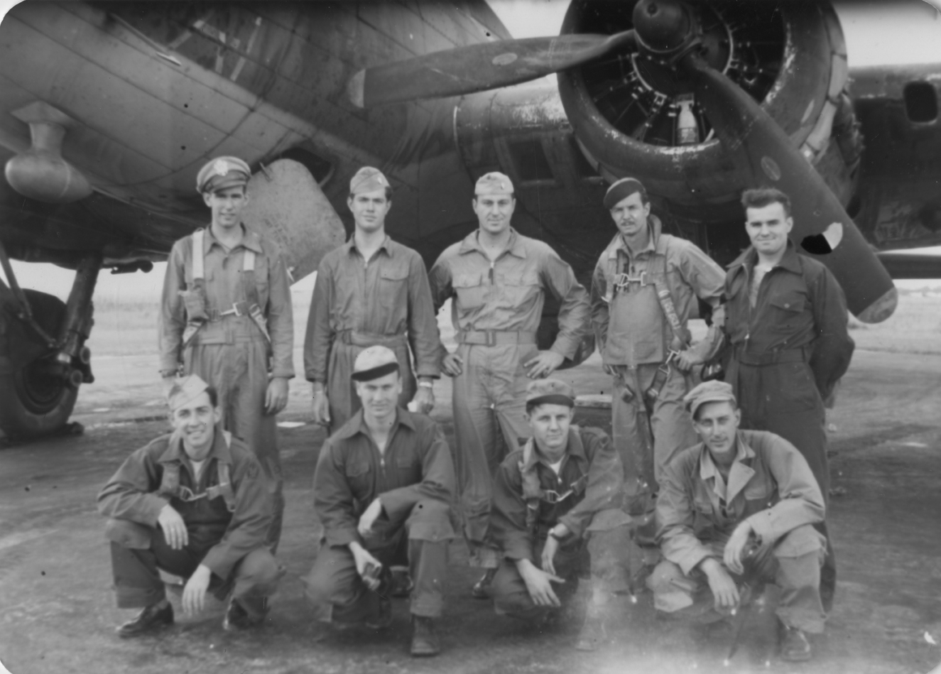 A bomber crew of the 95th Bomb Group with their B-17 Flying Fortress in Florida. Handwritten caption on reverse: ' Our Crew, Top Row, Left to Right: Bob-Fitz Lenny, Co-Pilot, California.Tom Gibson, Pilot, Tennessee. Bill Bell, Navigator, Pennsylvania. R.E. Nairn, Togglier/Armorer, Maryland. ? did not go into combat with us. Bottom Row: L-R Bernie Hagamon, Tail Gunner, Illinois. Dick Mawell, Engineer-Gunner, Illinois. Dick DeRanney, Ball Turret Gunner, Long Island, New York. "Rebel" Mayers, Radio Operater/