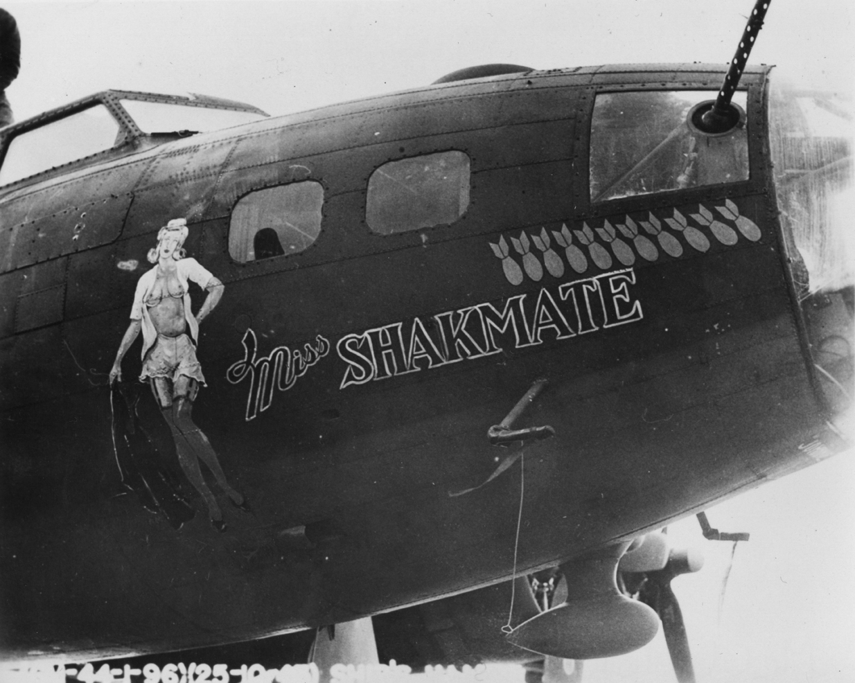 The nose art of a B-17 Flying Fortress nicknamed "Miss Shakmate" of the 96th Bomb Group. Official caption on image: "(GM-44-1-96)(25-10-43) Shake Mate." Handwritten caption on reverse: 'McClatchy (P)'.