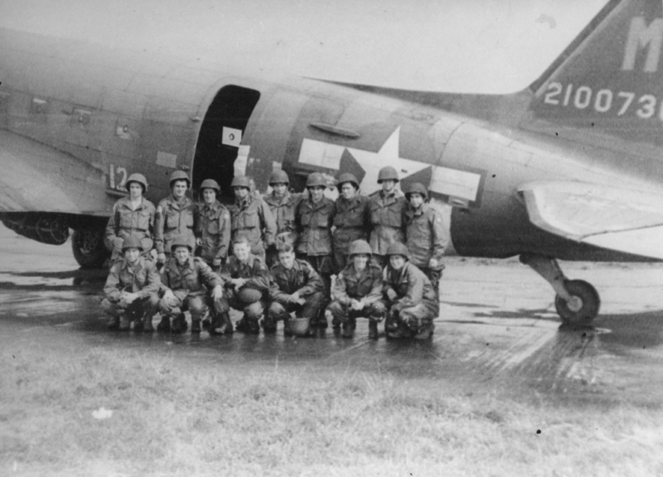 Paratroopers with a C-47 Skytrain of the 442nd Troop Carrier Group. Handwritten caption on reverse: 'Paratroopers before Holland mission. Fulbeck, England, Sept 1944. Ready for takeoff at runway.'