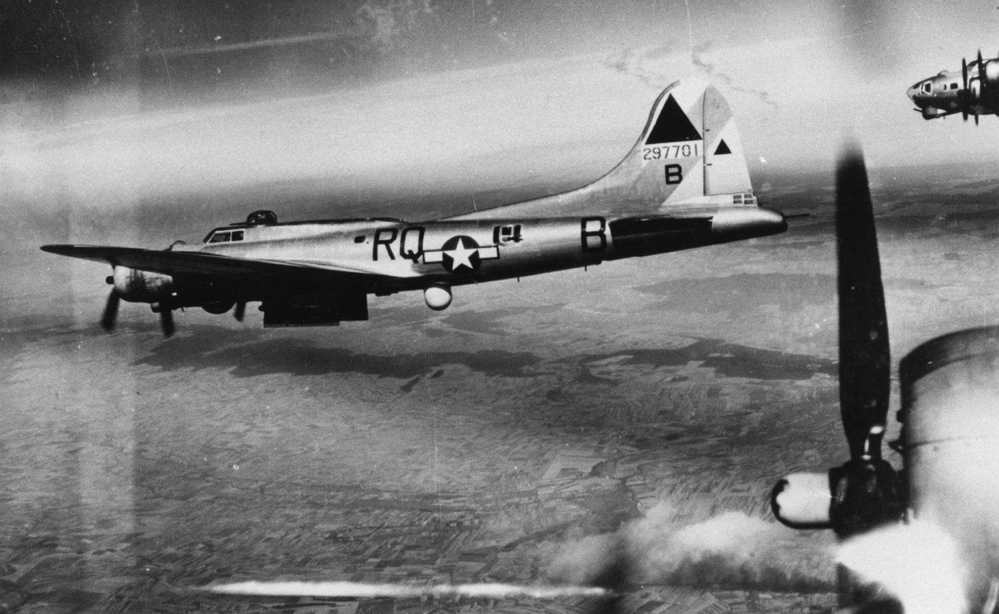 A pathfinder B-17 Flying Fortress (RQ-B, serial number 42-97701) of the 509th Bomb Squadron, 351st Bomb Group in flight during a mission over Weimar, 24 August 1944. Handwritten caption on image: "24.8.44. Weimar. 26,000 ft." Handwritten caption on reverse: 'Vic Maslen. Nadine L. 24-8-44, 279.'