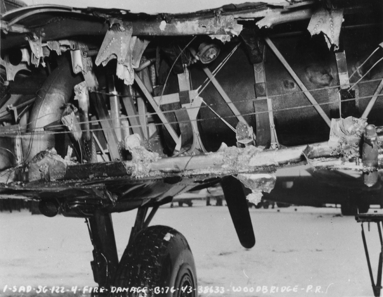 A battle damaged B-17G Flying Fortress (serial number 43-38633) of the 379th Bomb Group at Woodbridge. Official caption on image: "I-SAD-SG-122-4-Fire Damage - B17G - 43-38633 - Woodbridge - PR."