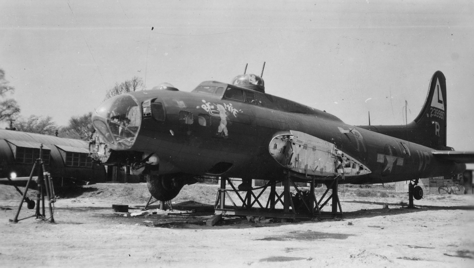 The wreck of a B-17 Flying Fortress (VP-R, serial number 42-39997) nicknamed "Big Mike" of the 533rd Bomb Squadron, 381st Bomb Group. Parts of the aircraft were salvaged and used for a B-17 nickanmed "French's Folly". Handwritten caption on reverse: '"Big Mike" (before). 381 B.G., 8th Air Force.' On reverse: Passed by US Army Examiner and David R. Osborne [Stamps].