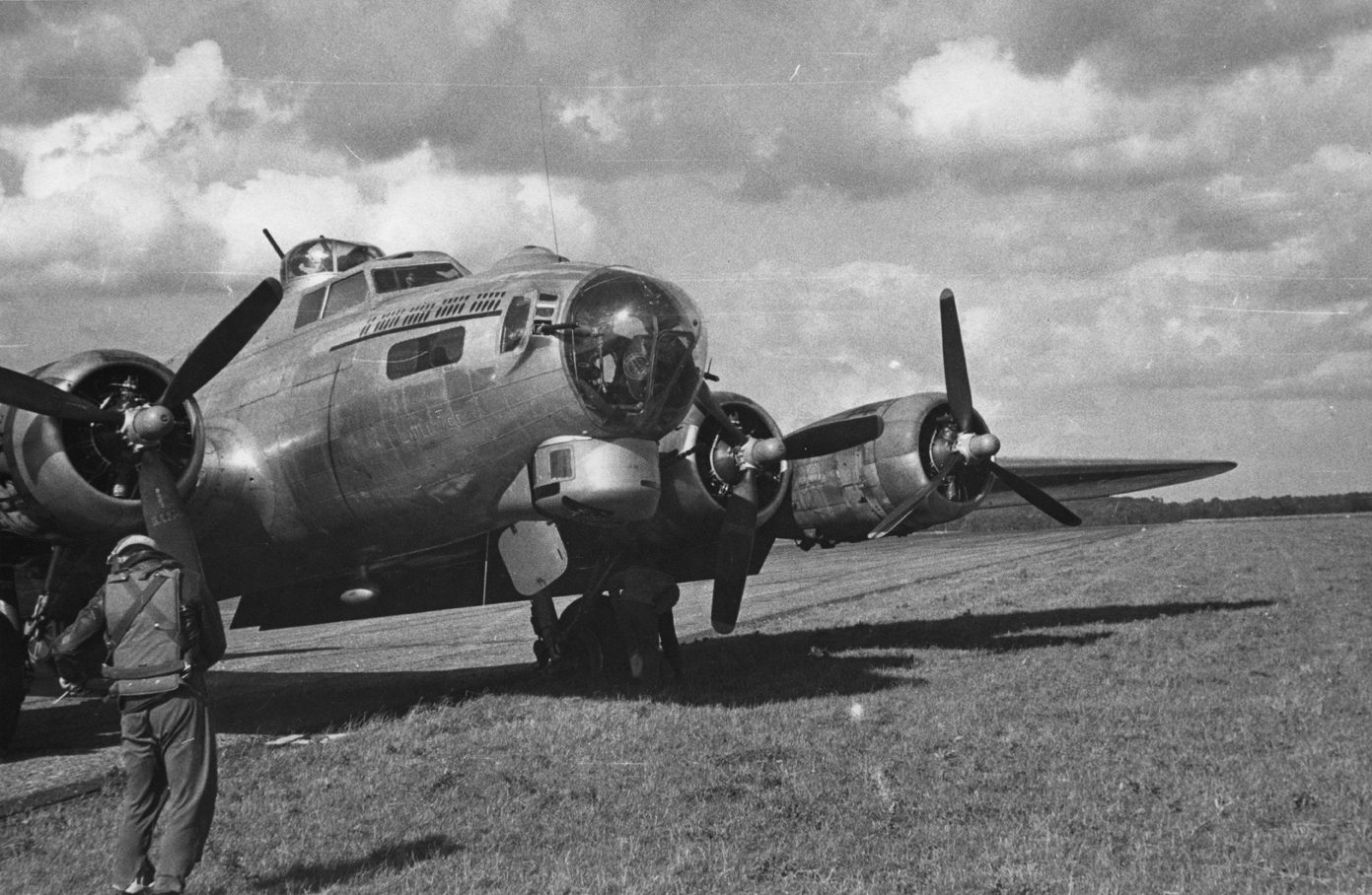 A airman of the 388th Bomb Group with a B-17 Flying Fortress nicknamed "Little Joe Jr.". Handwritten caption on reverse: '5/9/44 A. 282.'