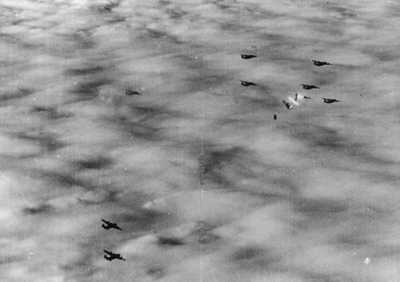 A B-24 Liberator nicknamed "The Oklahoman", piloted by Lieutenant Mason of the 389th Bomb Group bursts into flame during a mission, 5 December 1943. Handwritten caption on reverse: '5/12/43B - 2, 146. 146/RFWD148. See 147.'