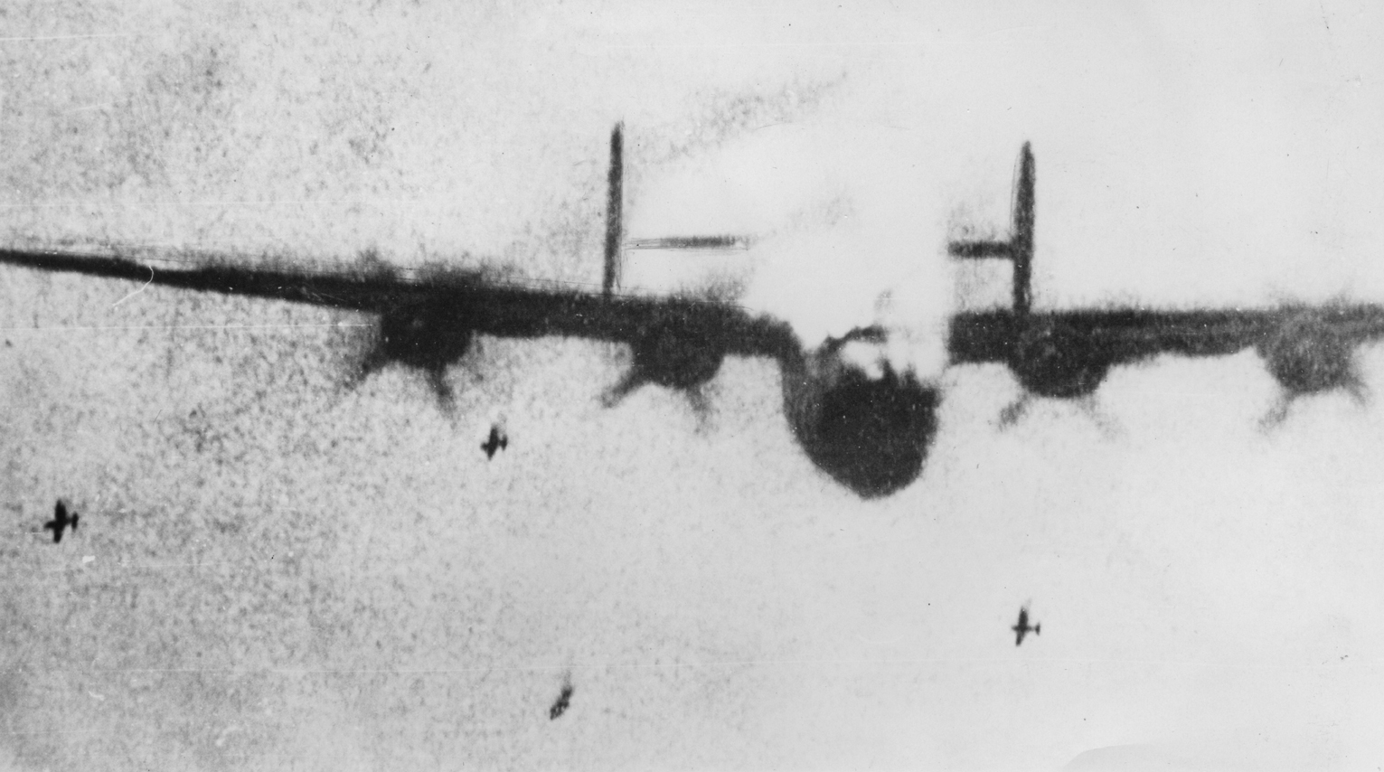 A B-24 Liberator of the 453rd Bomb Group burns as a result of a direct hit from a Focke-Wulf 190. Gun camera image. Handwritten caption on reverse: 'B-24 on fire. German gun camera film; FW190s attacking B-24s. 114.'