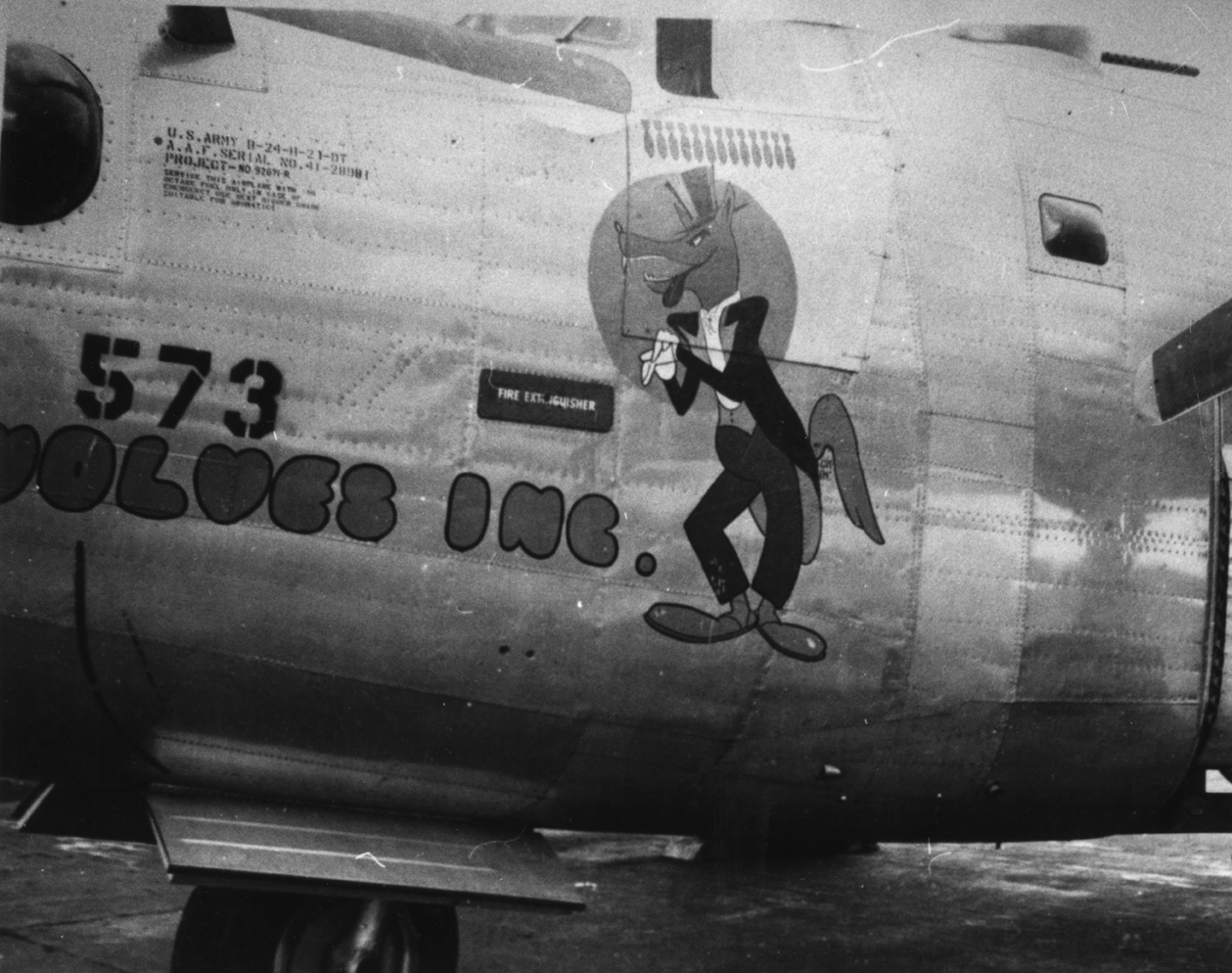 The nose art of a B-24 Liberator (4Z-V+) nicknamed "Wolves Inc." of the 791st Bomb Squadron, 467th Bomb Group. Handwritten caption on reverse: '467th B.G., 4Z-V+.'