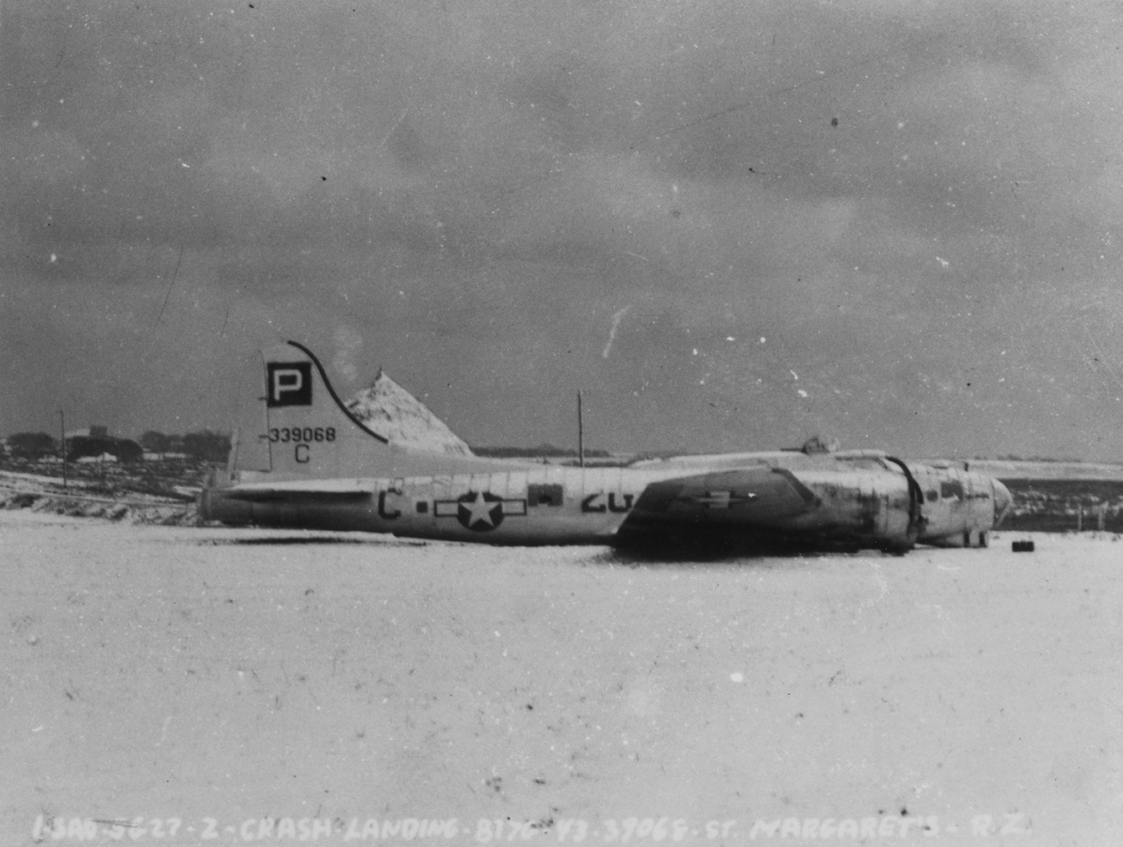 A side view of a B-17G Flying Fortress (2G-C, serial number 43-37068) of the 836th Bomb Squadron, 487th Bomb Group that crash-landed at St. Margaret's. Official caption on image: "ISAD - 5627 - 2 - Crash Landing - B-17G - 43-37068 - St. Margaret's - R.Z."