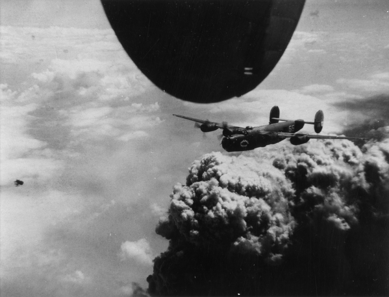 A B-24 Liberator (serial number 41-29580) nicknamed "Screamin' Meemie II" of the 451st Bomb Group, 15th Air Force in flight during a mission over Ploesti, 1944. Handwritten caption on reverse: '451 BG, Screamin Meemie II, 15/7/44 Ploesti.'