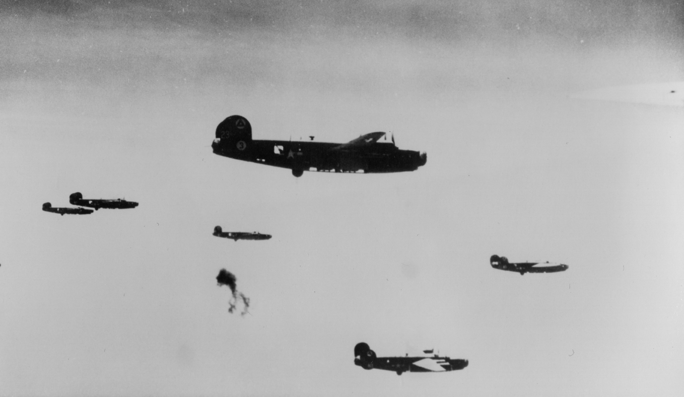 Pathfinder B-24 Liberators of the 450th Bomb Group, 15th Air Force fly in formation through flak.