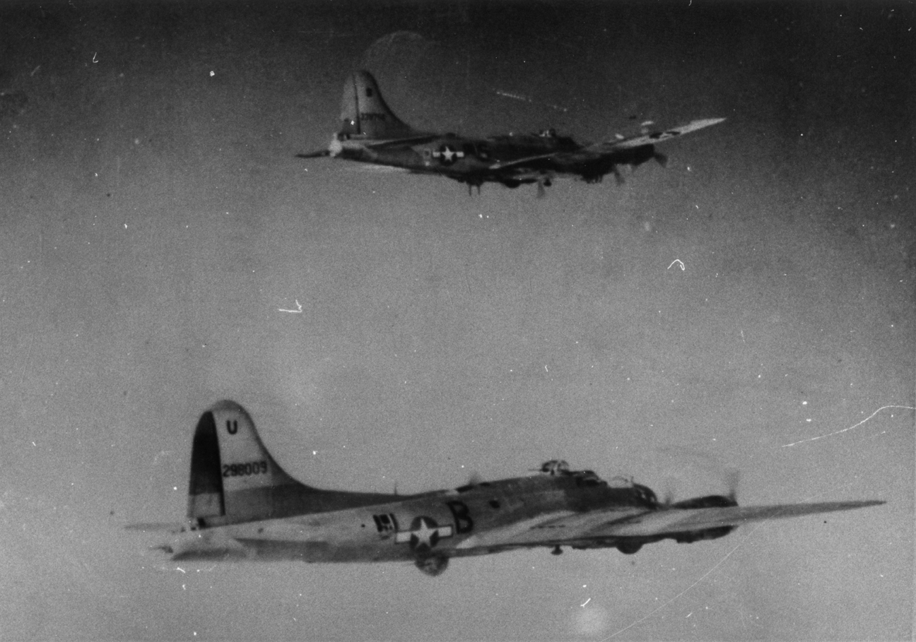 Two B-17 Flying Fortresses, (serial number 42-98009) and (serial number 43-38754) of the 493rd Bomb Group in flight. Handwritten caption on reverse: '338754 S, 298009 B, Ed O Neill, 493 BG.'