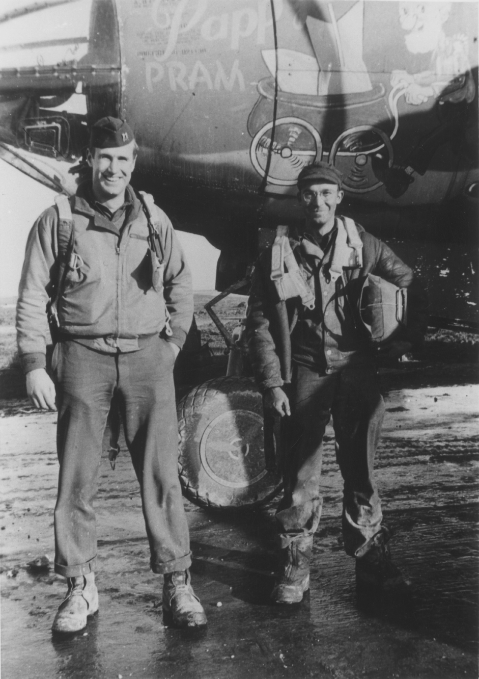 Two airmen of the 322nd Bomb Group by the nose of a B-26 Marauder nicknamed "Pappy's Pram". Handwritten caption on reverse: '"Pappy's Pram", 322BG.'