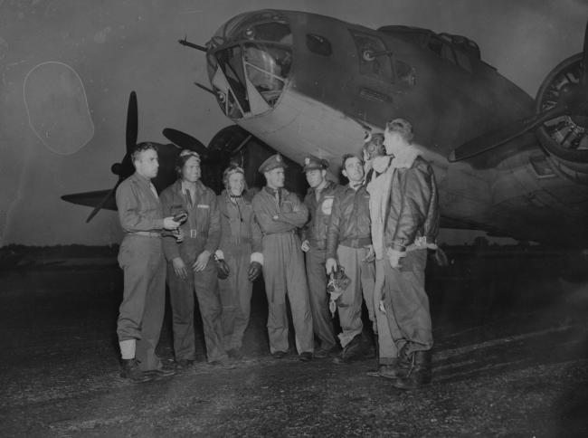 A bomber crew of the 97th Bomb Group with their B-17 Flying Fortress. They are from left to right: Lieutenant Frank R. Beadle, of Grand Rapids, Michigan; Sergeant Chester Love, of Cincinnati, Ohio; Sergeant Richard Williams, of Utica, New York; Lieutenant Levon Ray, of Poolville Texas; Glen V. Leland, of St. Petersburg, Florida; Sergeant Frank Rebello, Tiverton, Rhode Island; Sergeant Joseph Cummings, of Oskaloosa, Iowa; and Sergeant Zane Gemmill, of St. Clair, Pennsylvania. Image stamped on reverse: 'Pas